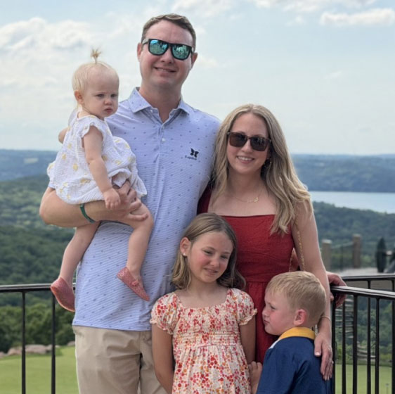Andrew Seaman's family outdoors overlooking a picturesque landcape